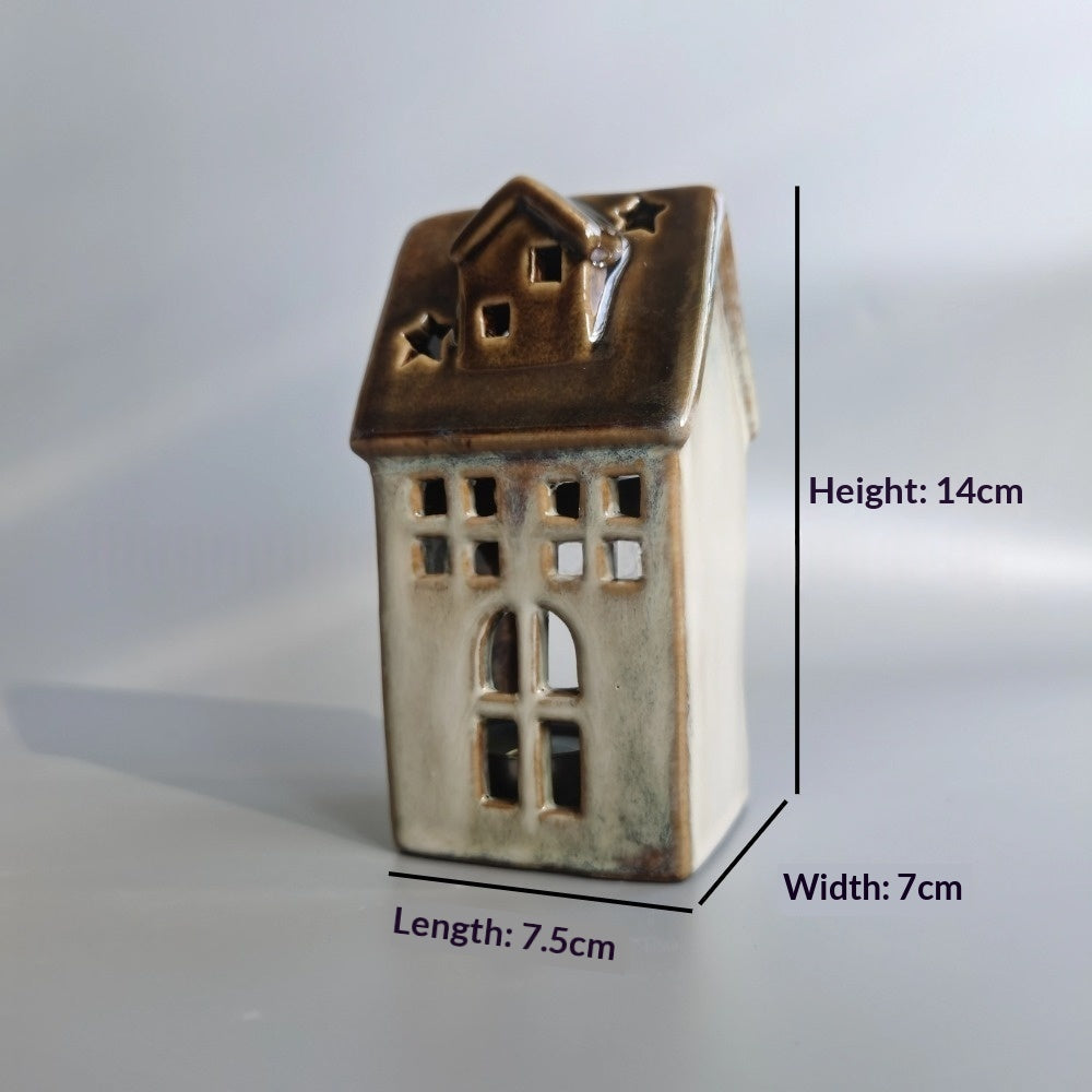 Glazed ceramic Christmas house with brown roof and star cut-outs, about 14 cm