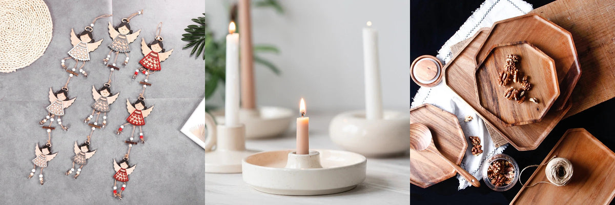 Wooden angel garlands, a lit candle in a cream ceramic holder and acacia wood plates with walnuts